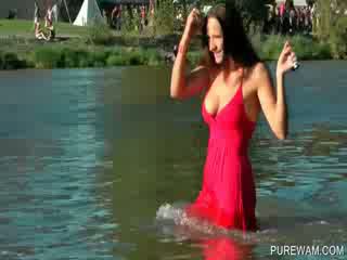 Superb brunette getting wet in the lake